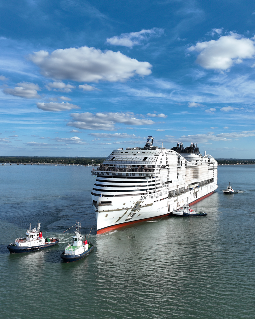 MSC World Atlantic is guided by tugboats during her float out in Saint-Nazaire
