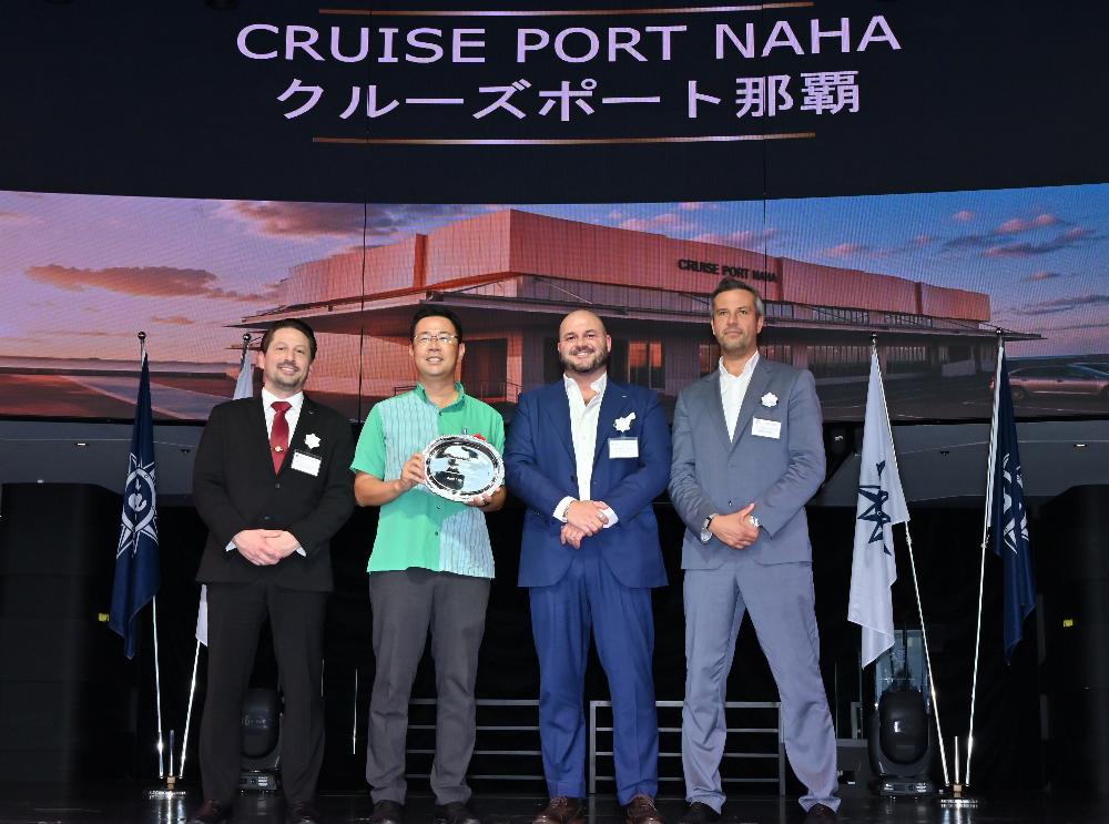 Representatives at the Naha cruise terminal project presentation in front of the planned terminal rendering