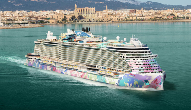 Norwegian Bella cruise ship sailing at sea with colorful hull artwork